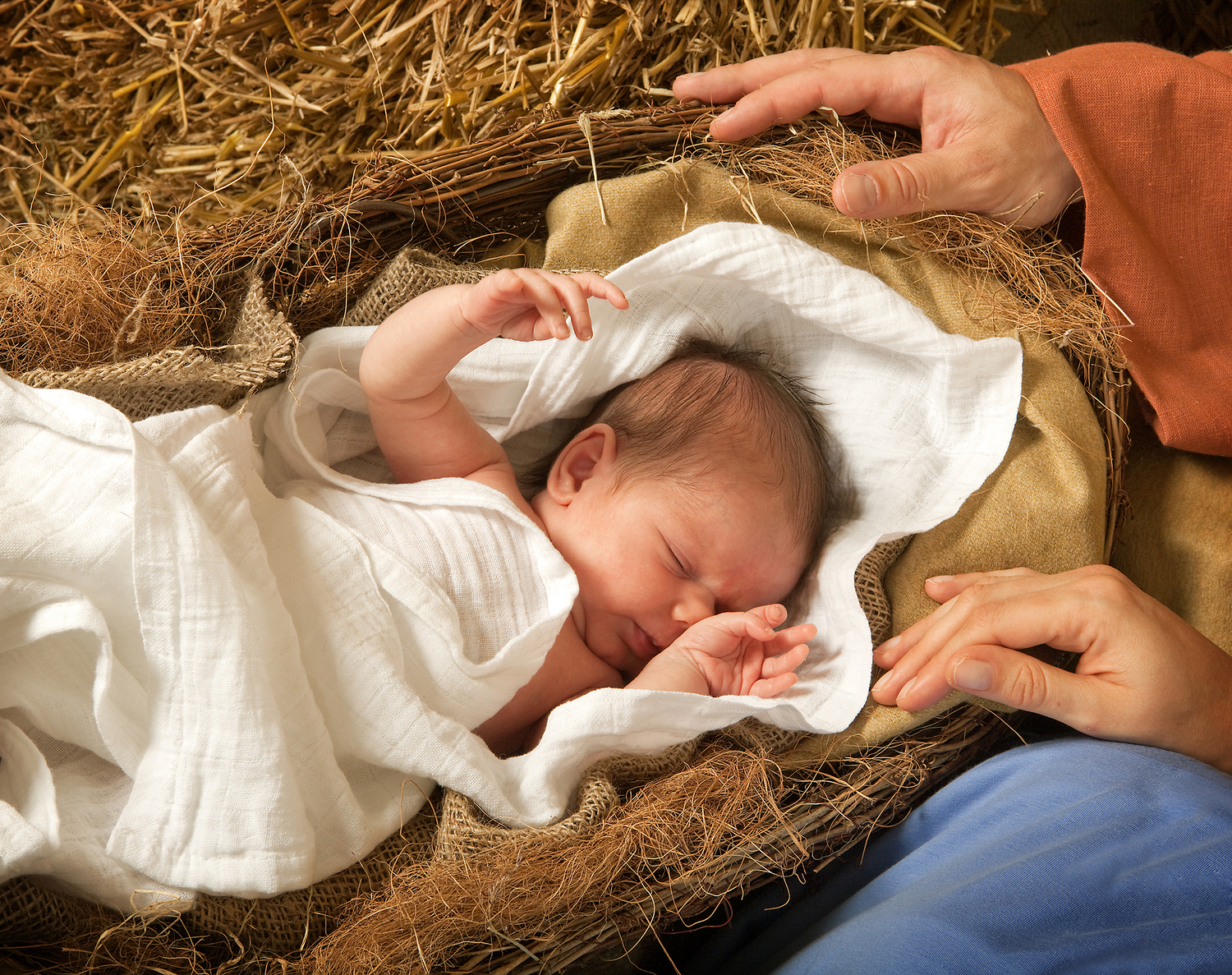 20 days old baby sleeping in a christmas nativity crib